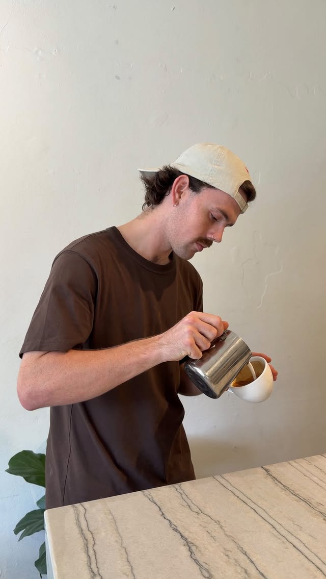 Barista pouring latte art